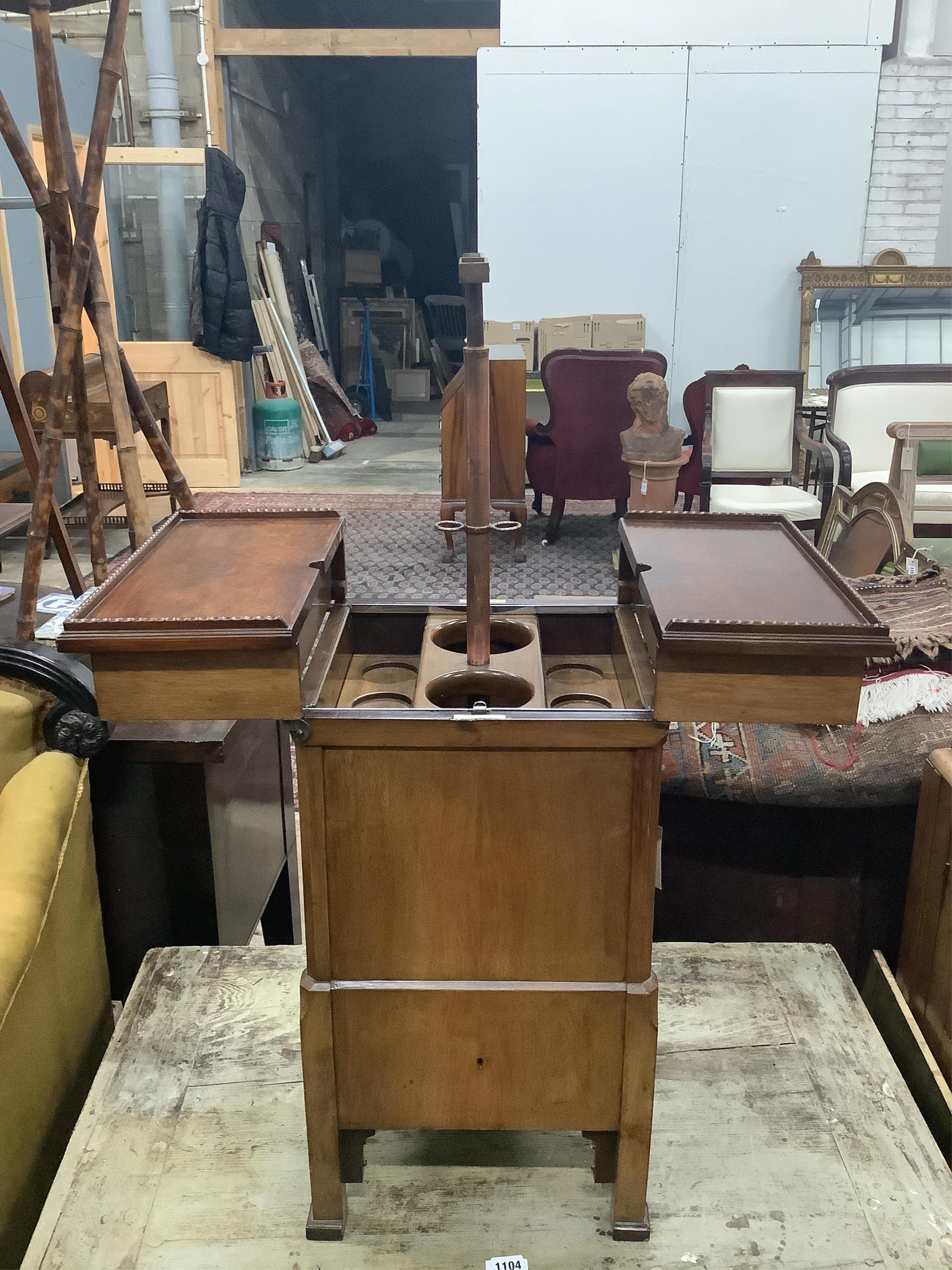 An early 20th century brass mounted mahogany 'Surprise' patent drink's cabinet, retailed by Goldsmiths & Silversmiths Co., width 37cm, depth 36cm, height 68cm. Condition - good